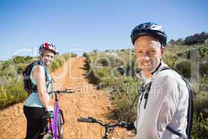 Active couple cycling on country terrain together