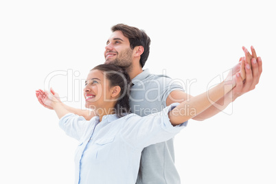 Cute couple standing with arms out