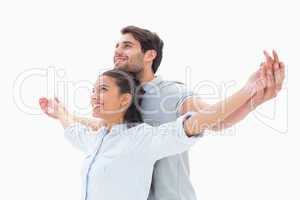 Cute couple standing with arms out