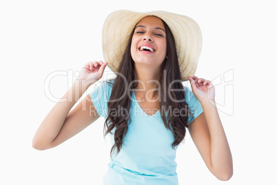 Happy young brunette wearing sunhat