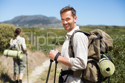 Happy hiking couple walking on country trail