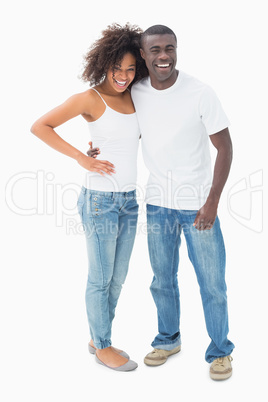 Attractive couple in matching clothes smiling at camera