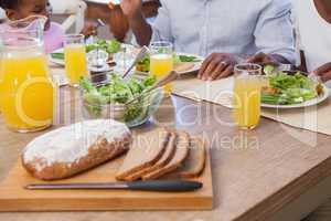 Family having lunch together of bread and salad
