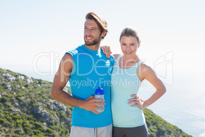 Fit couple standing at summit