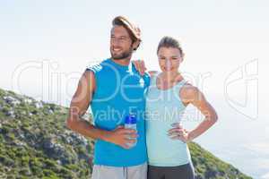 Fit couple standing at summit