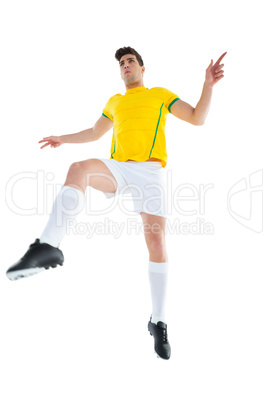 Football player in yellow jersey kicking