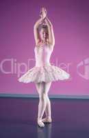 Graceful ballerina standing in fifth position