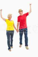 Mature couple walking and holding hands