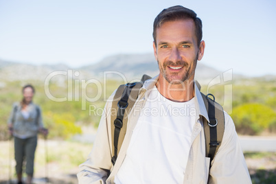 Happy hiking couple walking on mountain trail