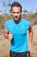 Athletic man jogging in the countryside