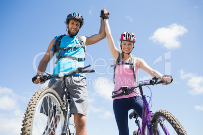 Fit cyclist couple happy to have reached the summit