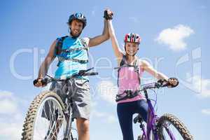 Fit cyclist couple happy to have reached the summit