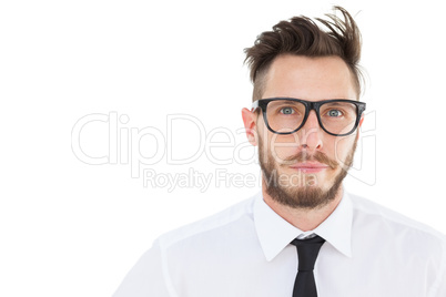 Geeky young businessman looking at camera