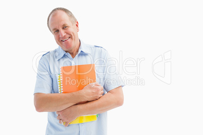 Happy mature student holding notebooks