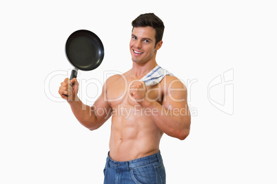 Portrait of a shirtless muscular man holding frying pan