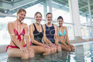 Female aqua aerobics class smiling at camera