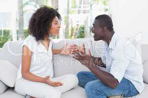 Attractive couple having an argument on couch