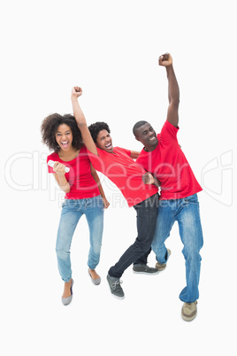 Football fans in red cheering together