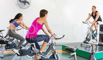 Spin class working out with motivational instructor