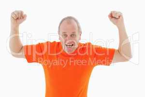 Mature man in orange tshirt cheering