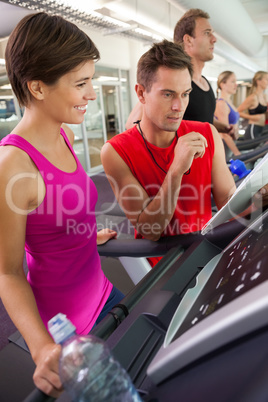 Trainer talking to his client on the treadmill