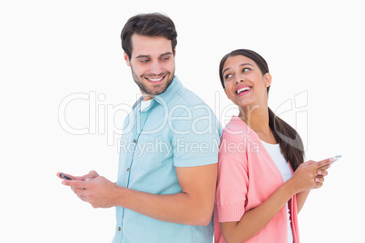 Happy couple sending text messages