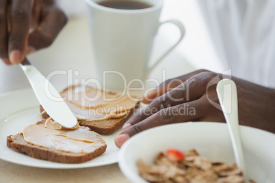 Man in bathrobe having breakfast on terrace