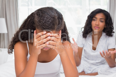 Mother and daughter having an argument on bed