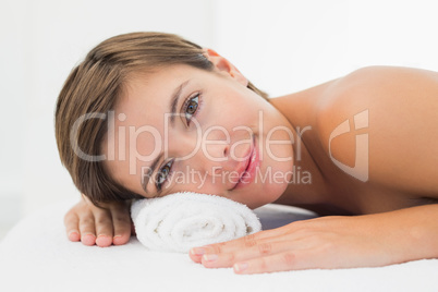 Beautiful woman lying on massage table at spa center