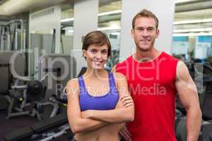 Fit attractive couple smiling at camera