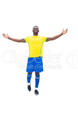 Football player in yellow celebrating a win