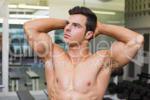 Muscular man looking away in gym