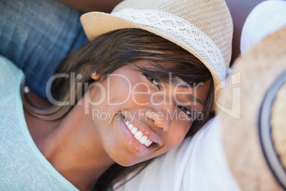 Smiling woman lying on partners lap outside