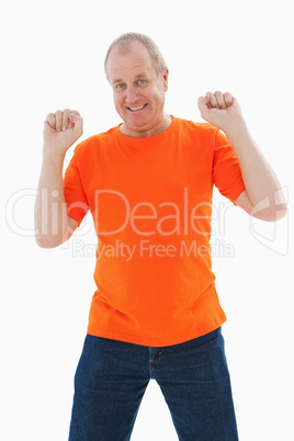 Mature man in orange tshirt cheering