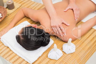 Woman enjoying a herbal compress massage