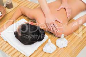 Woman enjoying a herbal compress massage