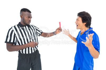 Serious referee showing red card to player