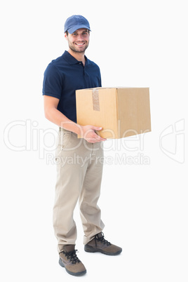 Happy delivery man holding cardboard box