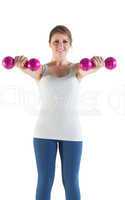 Smiling young woman with dumbbells