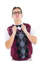Geeky hipster fixing his bow tie