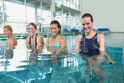 Female fitness class doing aqua aerobics