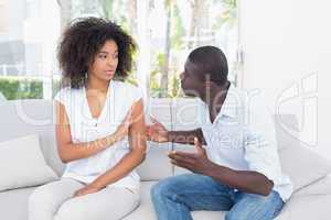 Attractive couple having an argument on couch