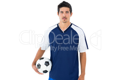 Football player in blue holding ball