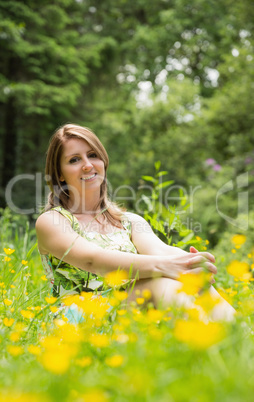 Cute young woman relaxing in field