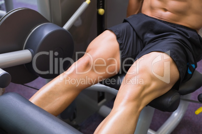 Mid section of muscular man doing a leg workout