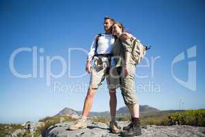 Hiking couple looking out over mountain terrain