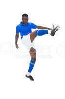 Football player in blue kicking