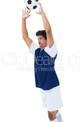 Football player in white throwing ball