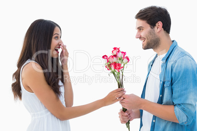 Happy hipster giving his girlfriend roses