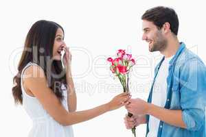 Happy hipster giving his girlfriend roses